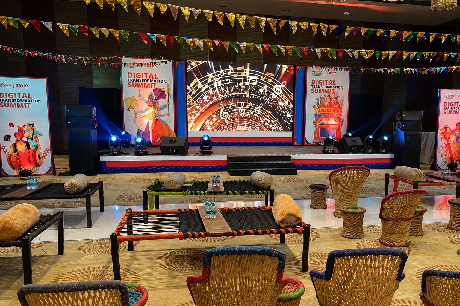 Culturally themed corporate summit with traditional seating and LED stage