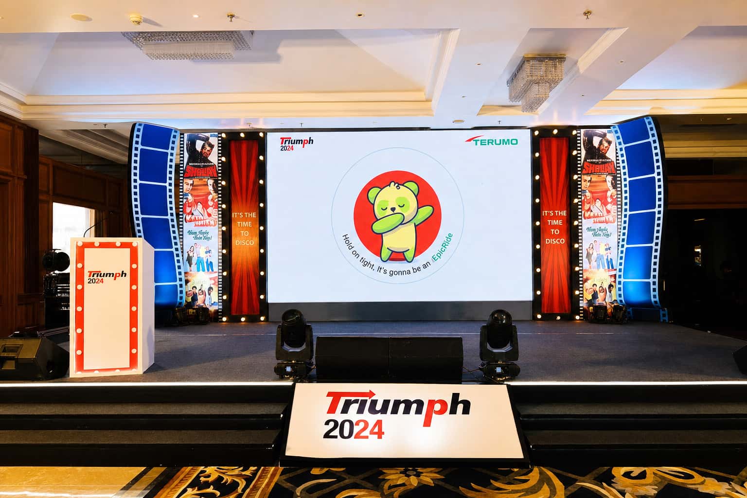 Themed corporate stage with LED wall and cinematic frames